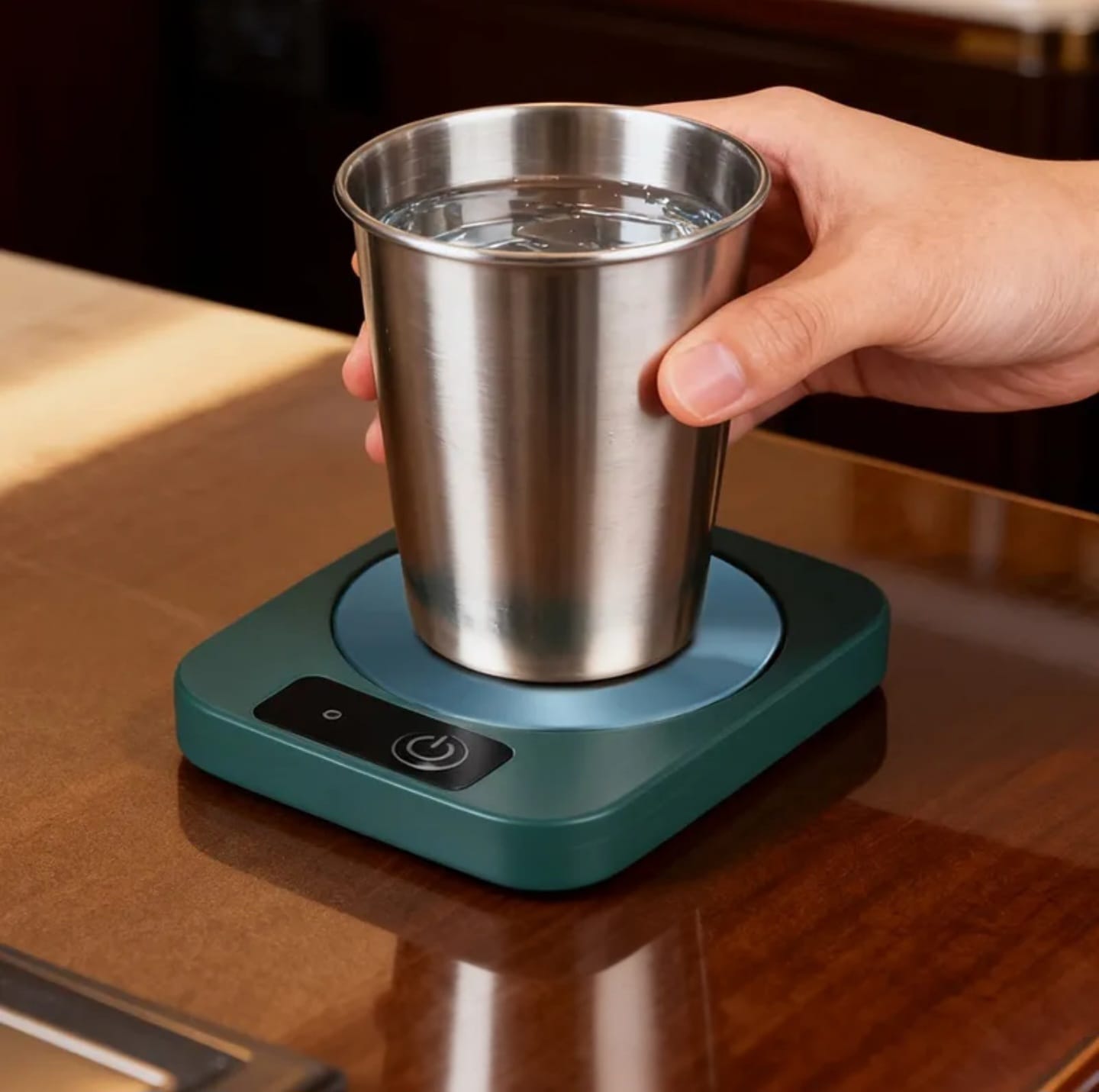 USB mug warmer with temperature control holding a stainless steel cup